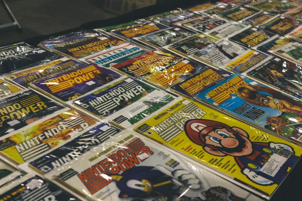 Many vintage nintendo power magazines displayed on a table, illustrating gaming media and collecting